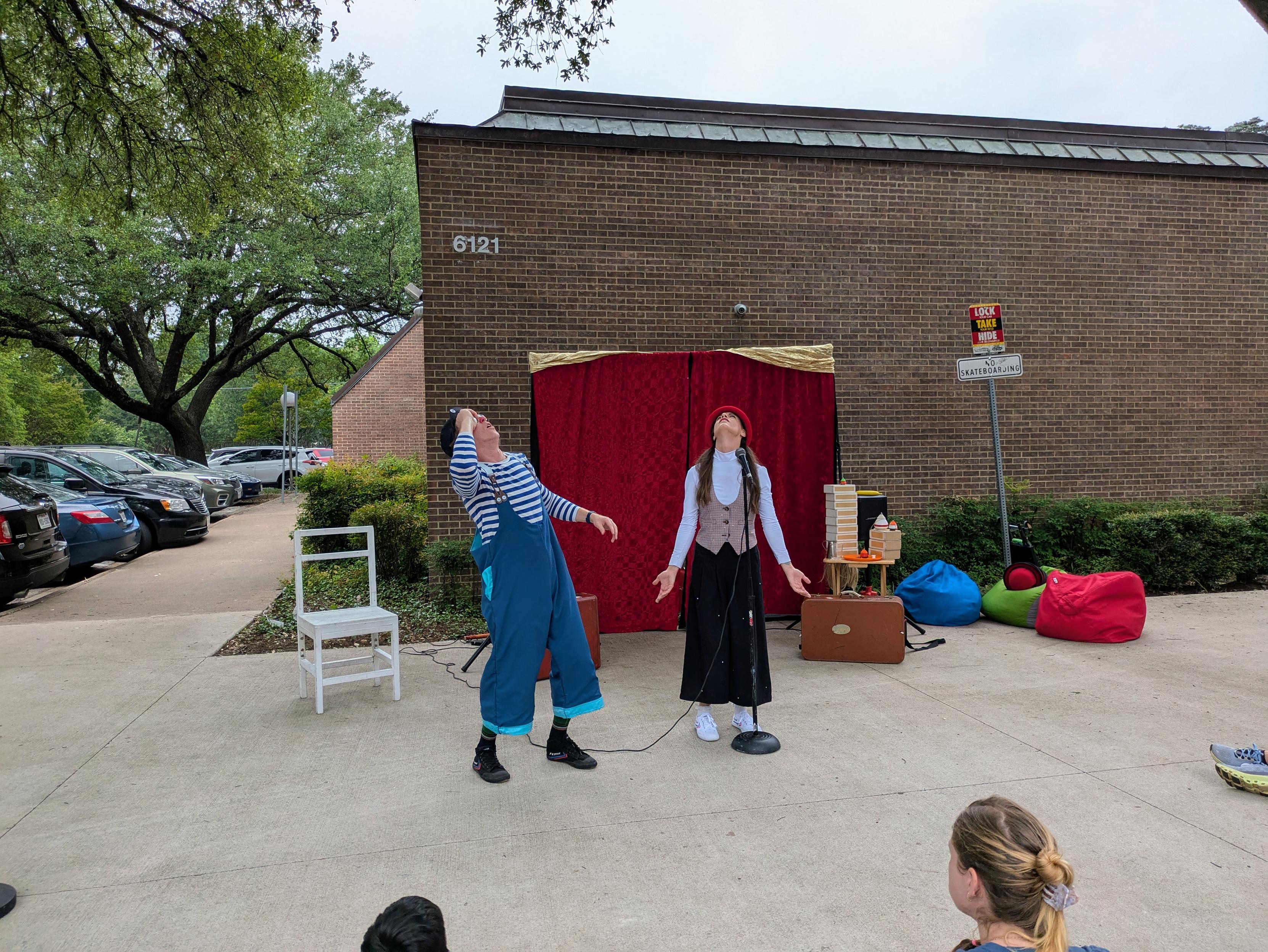 Clowns performing outside a library