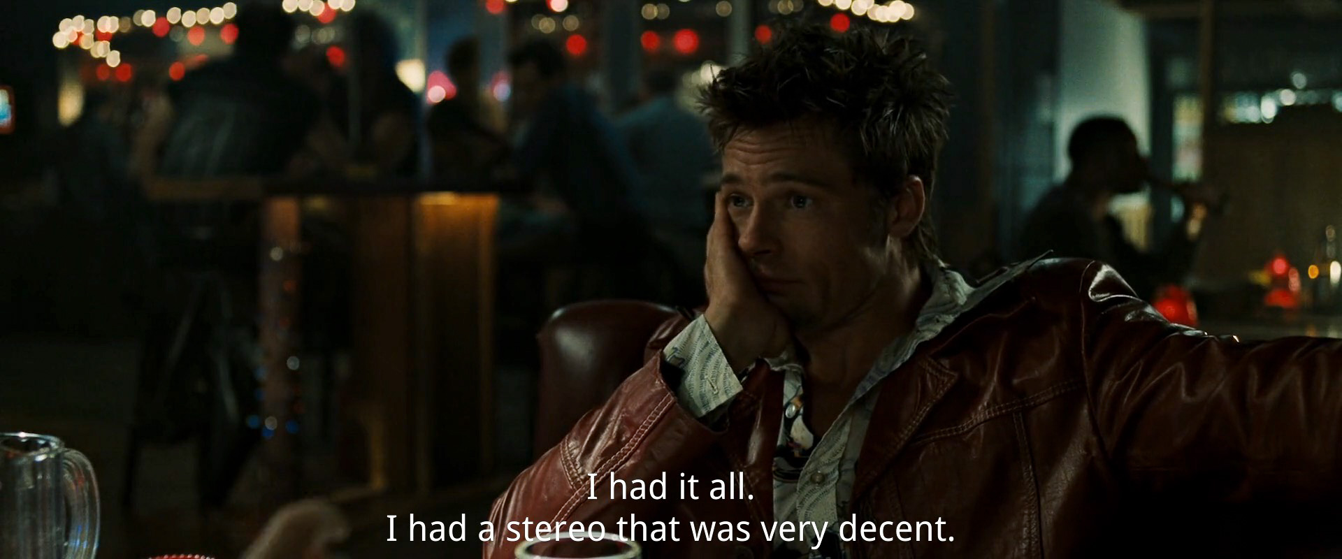 Still from Fight Club: Tyler Durden listening to the narrator say, "I had it all. I had a stereo that was very decent."